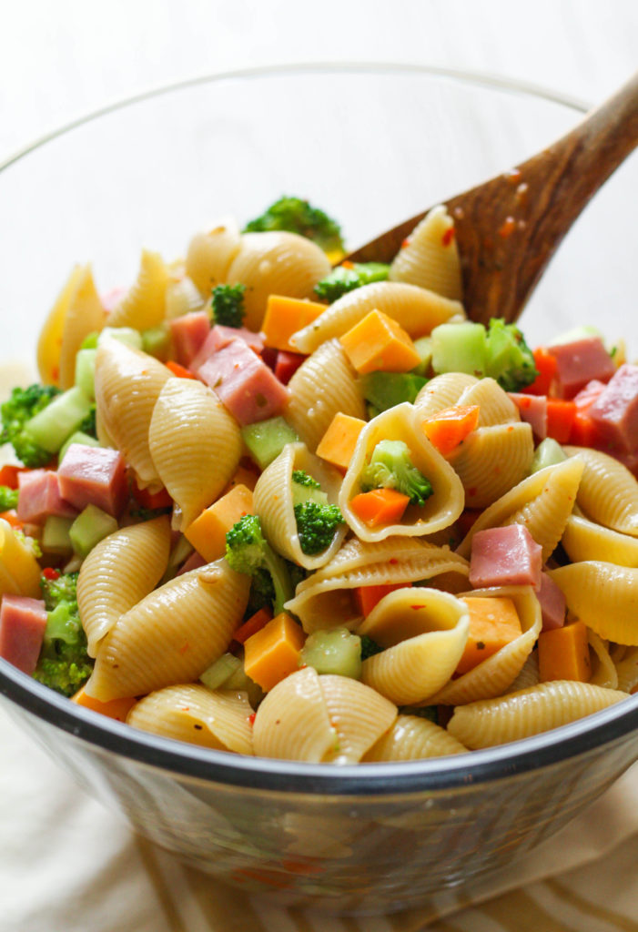 Garden Party Pasta Salad: Packed with crunchy veggies, ham, cheddar cheese and tossed with zesty Italian dressing, this pasta salad is sure to be a hit at your next picnic or barbecue.
