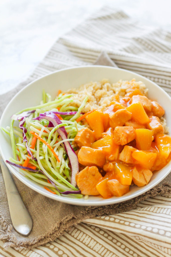 Instant Pot Sweet and Sour Chicken with Pineapple is sure to be a huge hit! Moist, tender chicken pieces are covered with a tangy sweet n' sour sauce, paired with pineapple, brown rice and an Asian broccoli slaw. 