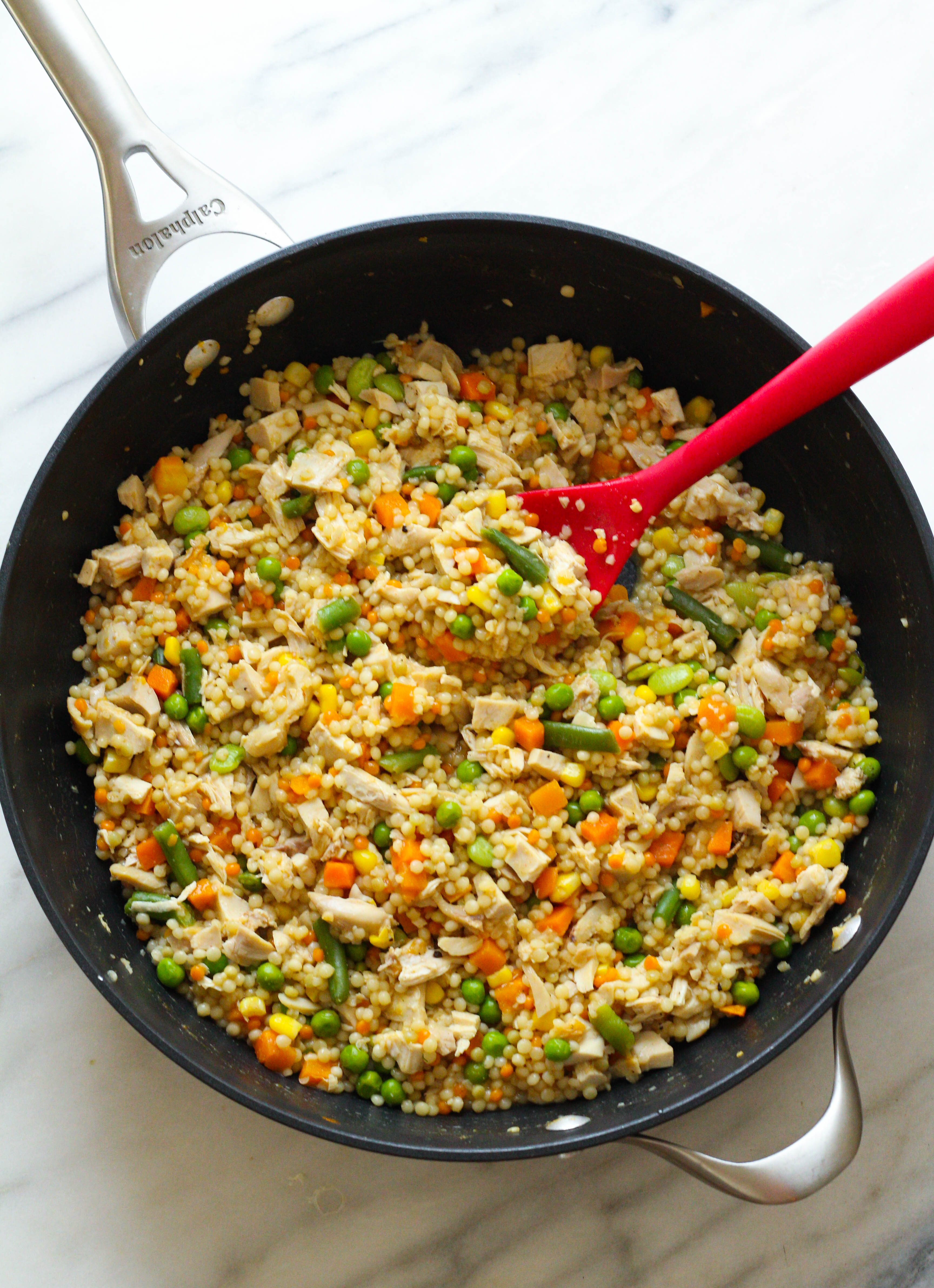 Pearled couscous chicken, simmered in broth with mixed veggies. An easy, delicious dinner that can be ready in less than 15 minutes. 