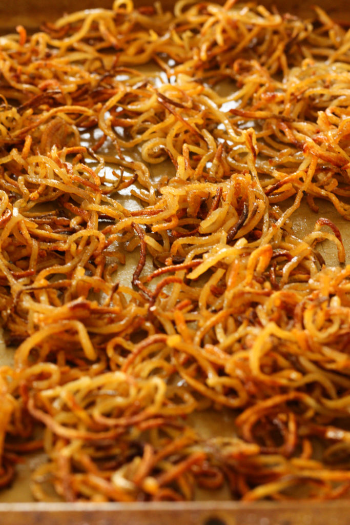 Buffalo shoestring potatoes are the perfect appetizer for your next get together! Spiralized potatoes crisp up quickly in the oven.