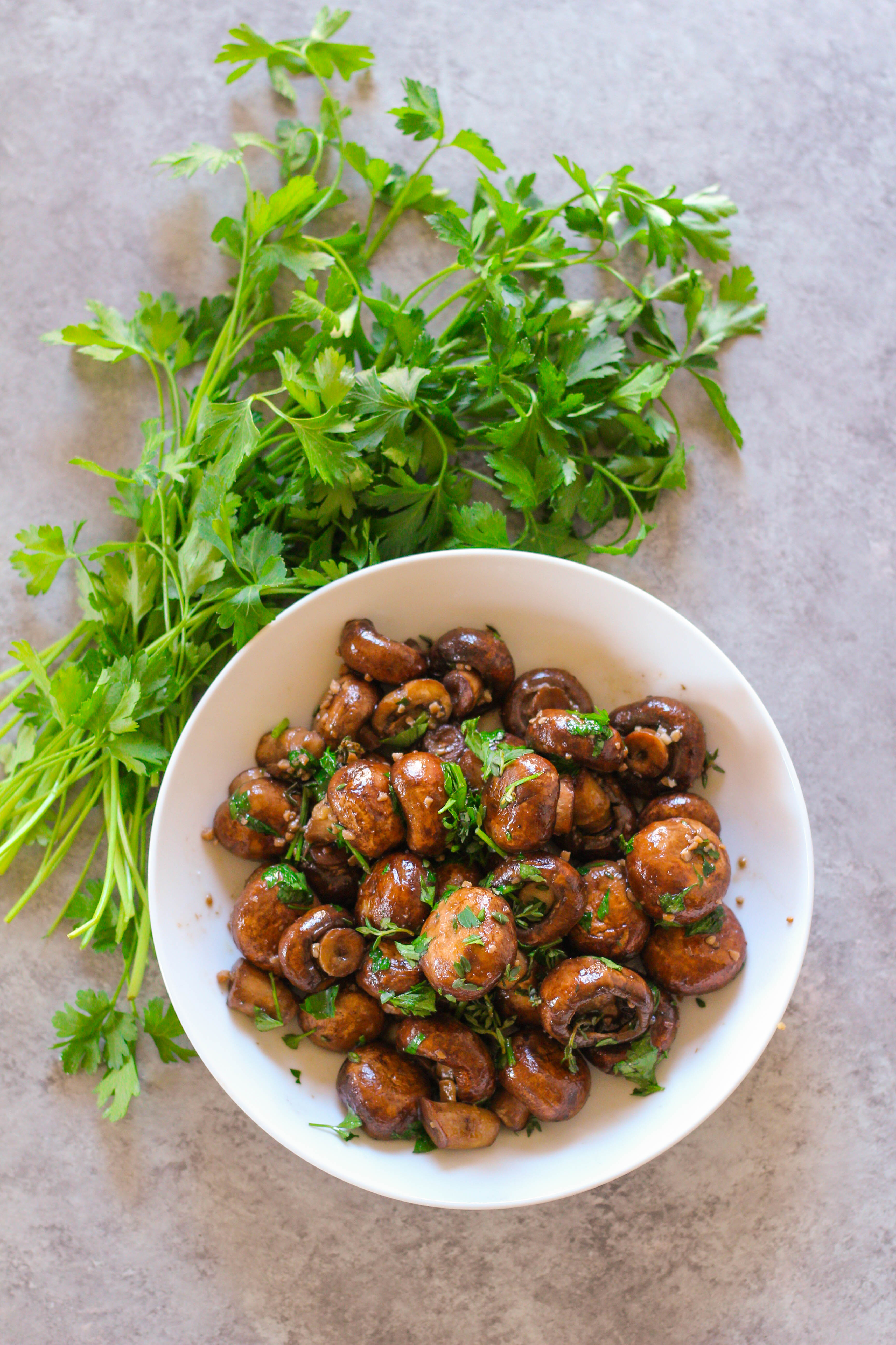 The perfect Spring side dish: savory cremini sauteed mushrooms in buttery ghee and tossed with fresh herbs. 