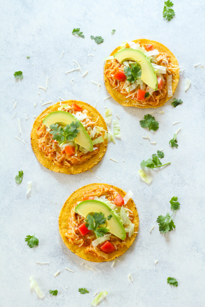 These Instant Pot Chicken Tostadas are super easy to make and perfect for your next fiesta! Covered in a sweet and spicy chipotle apricot glaze and goey melted cheese.