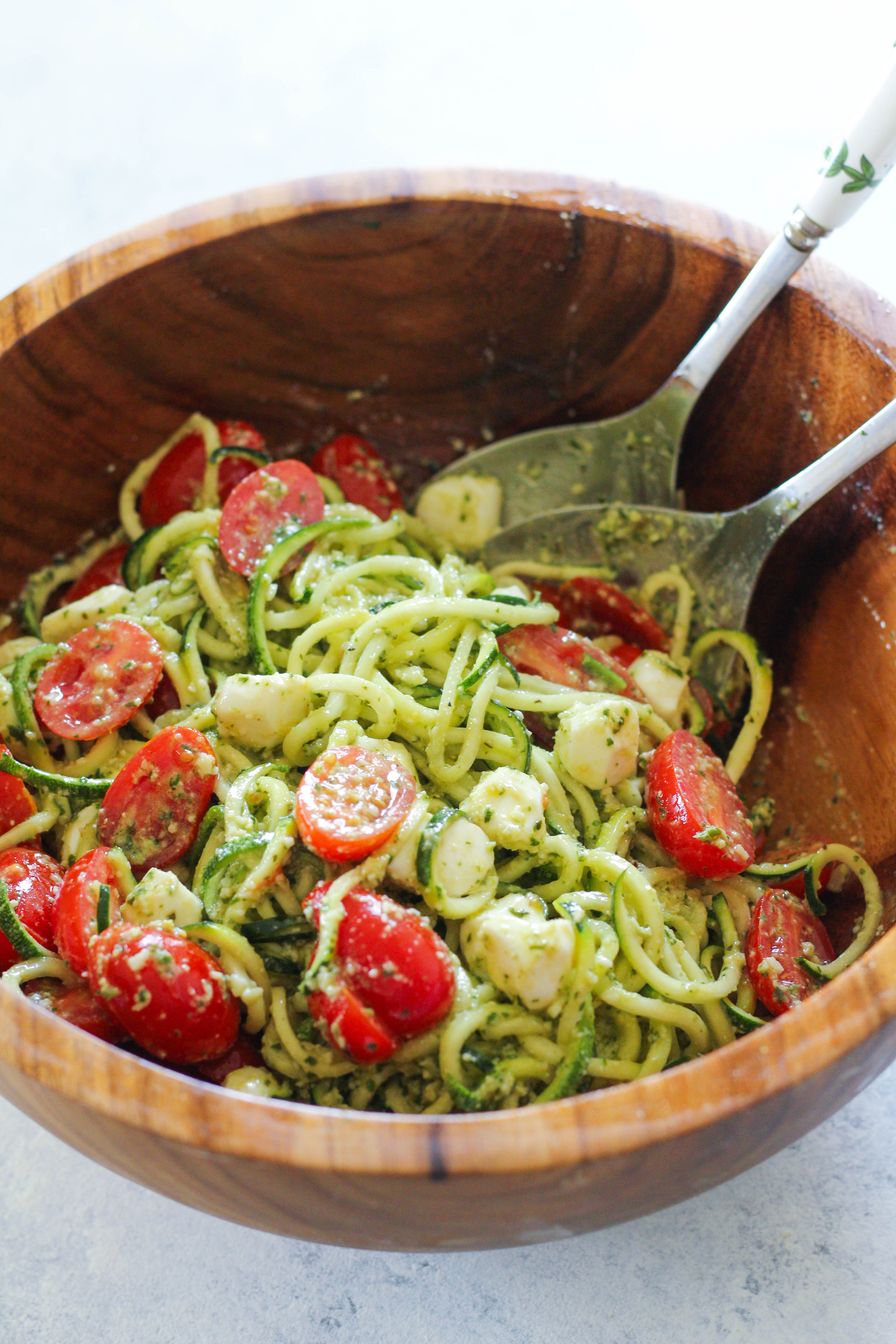  These Pesto Zucchini Noodles are a light and summery dish that doesn’t require a stove top or oven! Simply whip together a fresh basil pesto and toss zucchini noodles with cherry tomatoes and mozzarella pearls.
