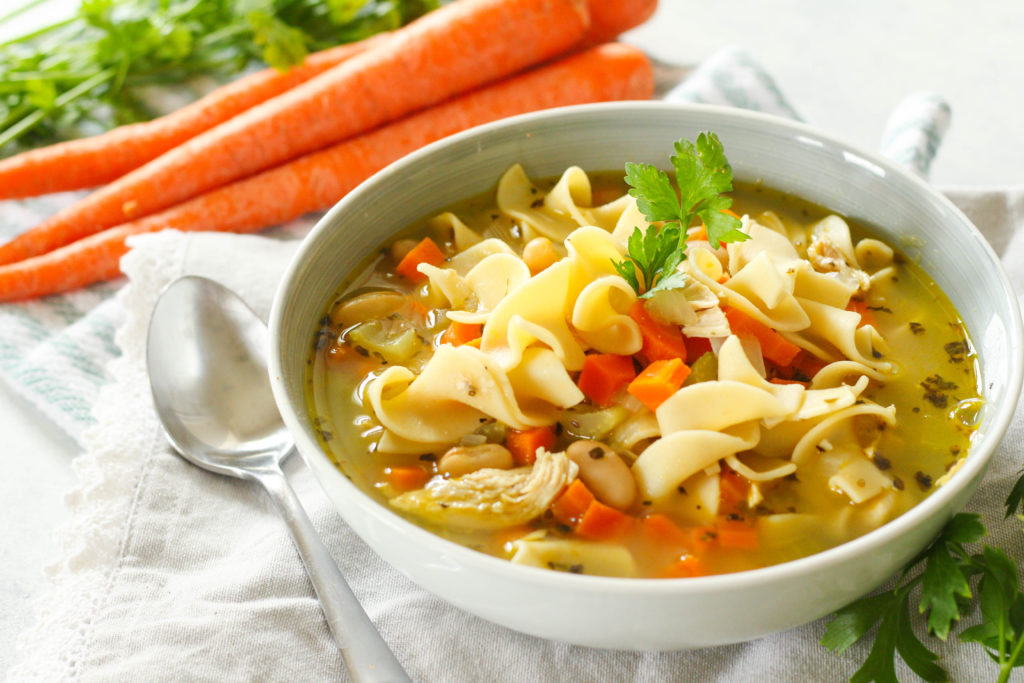 Homemade chicken noodle soup that's ready in under 30 minutes! Full of juicy chicken, tender beans, soft egg noodles and assorted veggies. 