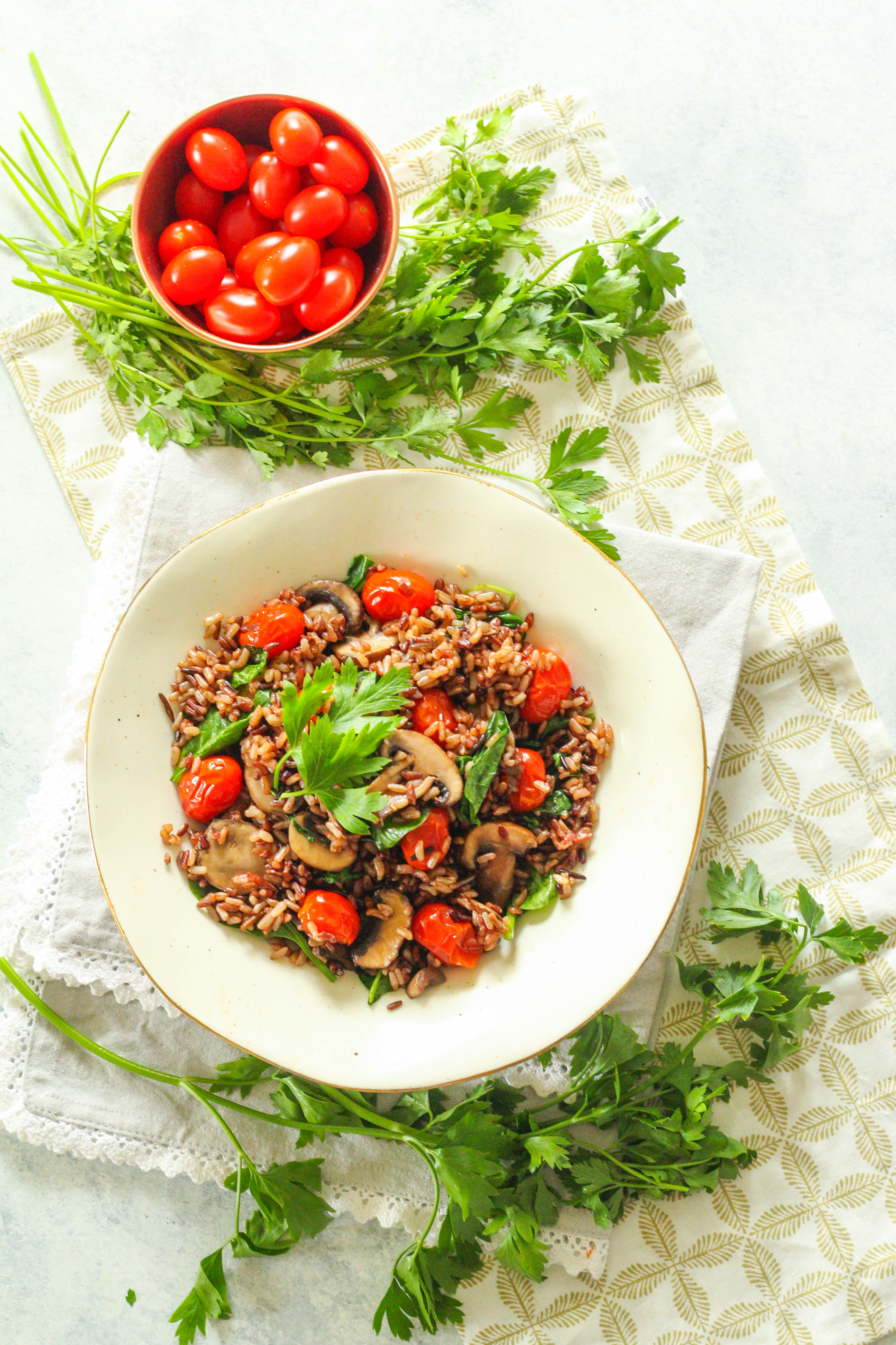 Delicious and filling, this Instant Pot Wild Rice Bowl is a comforting weeknight meal that won't heat up your kitchen in the summer months. Full of warm-weather flavors like baby spinach, burst sweet cherry tomatoes, and the addition of umami flavor from mushrooms. 