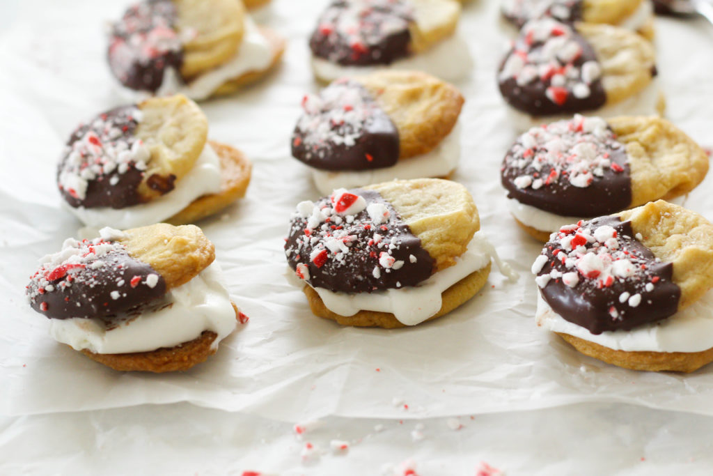 Chewy sugar cookies dipped in dark chocolate and covered with crushed peppermint patties, with a melted marshmallow sandwiched between. The perfect holiday cookie treat! Make these marshmallow cookies for your next holiday party or cookie exchange! 