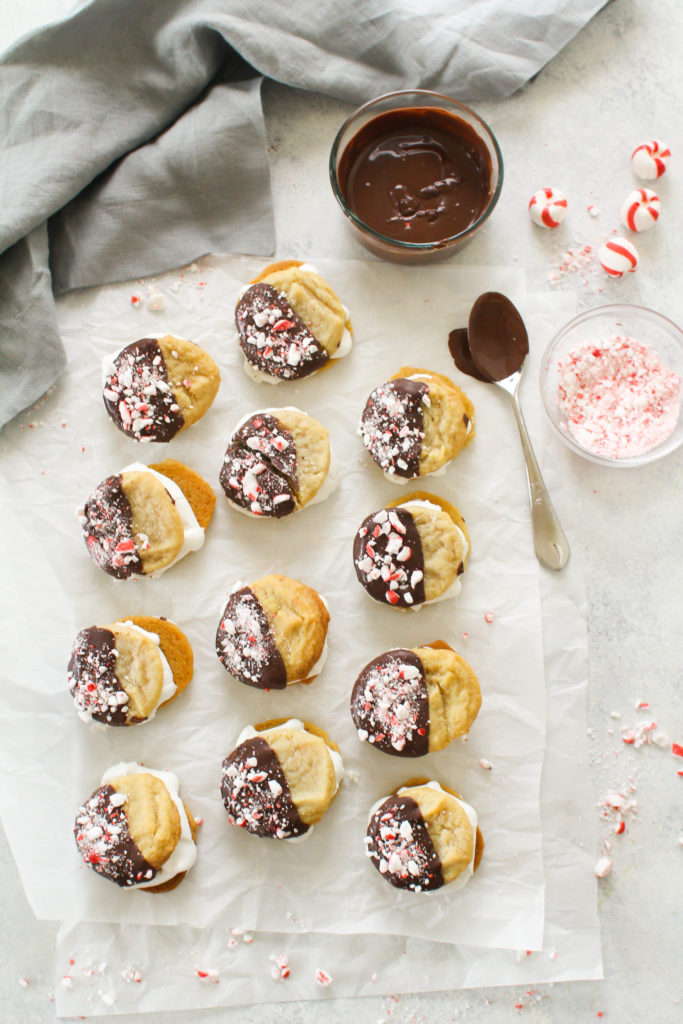 Chewy sugar cookies dipped in dark chocolate and covered with crushed peppermint patties, with a melted marshmallow sandwiched between. The perfect holiday cookie treat! Make these marshmallow cookies for your next holiday party or cookie exchange! 