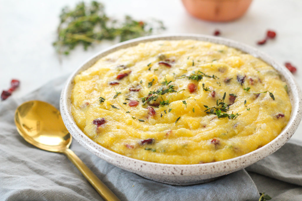 With a porridge-like consistency, creamy polenta is the perfect side dish to serve alongside hearty meat dishes this holiday season. Seasoned with fresh thyme, white wine and dried cranberries, this creamy polenta is sure to be a hit this holiday season! 