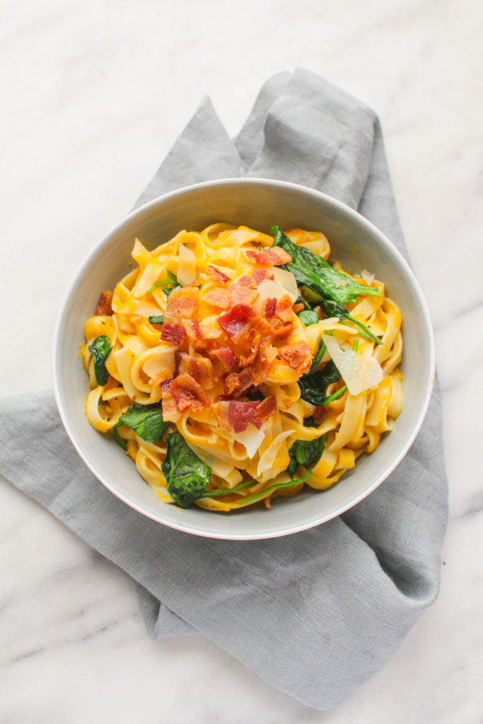 Tender butternut squash is pureed along with broth, spices and Parmesan cheese to create the base of this salty and savory pasta dish. Baby spinach is folded in for a delicious color contrast and it's all topped with crunchy bacon!