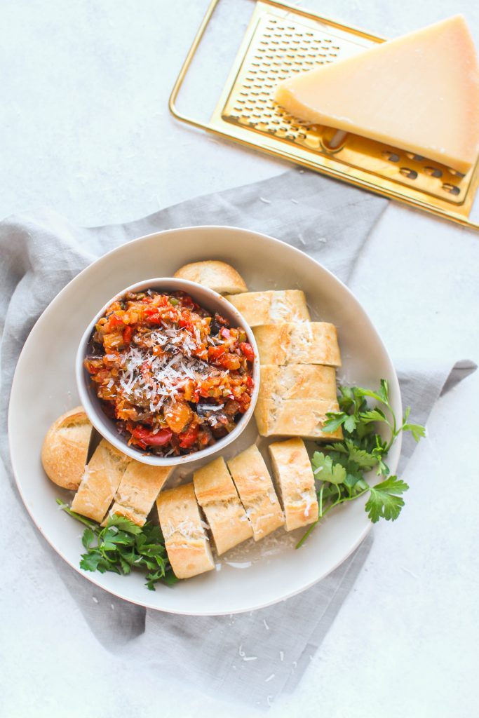 Caponata, a classic Sicilian dish, consists of diced eggplant and veggies in a olive and caper sweet and sour sauce. Eggplant Caponata can be served as-is or on top of sliced crusty bread.