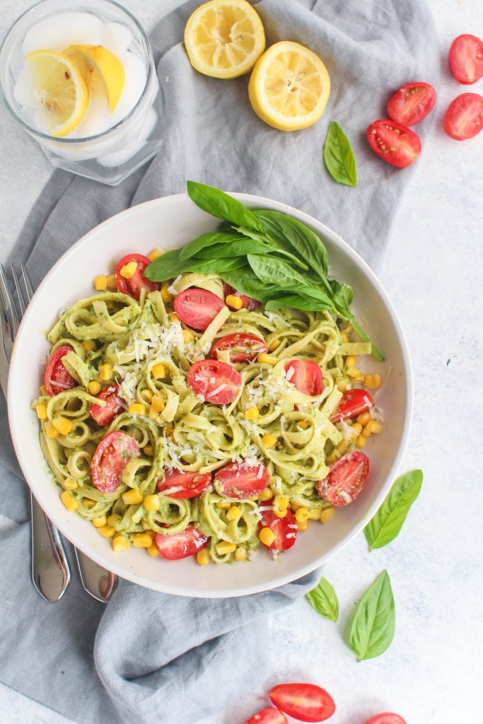 fettuccine with avocado sauce, cherry tomatoes and corn kernels