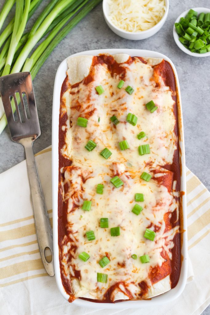 enchiladas covered in red sauce and cheese