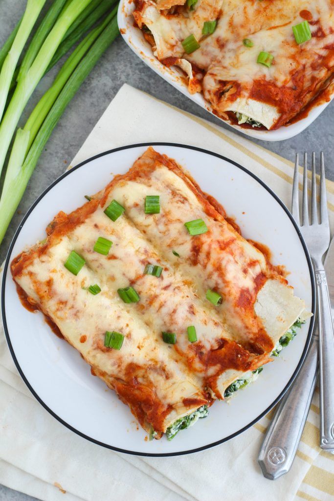 enchiladas covered with red sauce and cheese