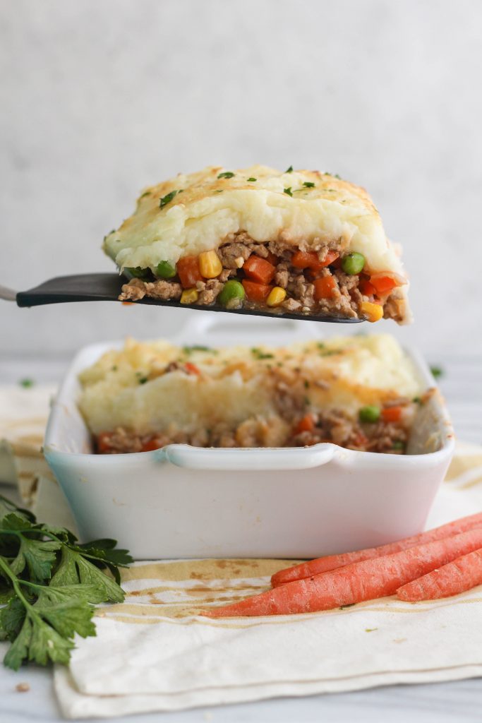 If you're in the mood for a meaty, savory, comfort food classic, try this Turkey Shepherd's Pie! Vegetables and ground turkey covered in a gravy sauce, topped with mashed potatoes and Parmesan, baked until golden. 