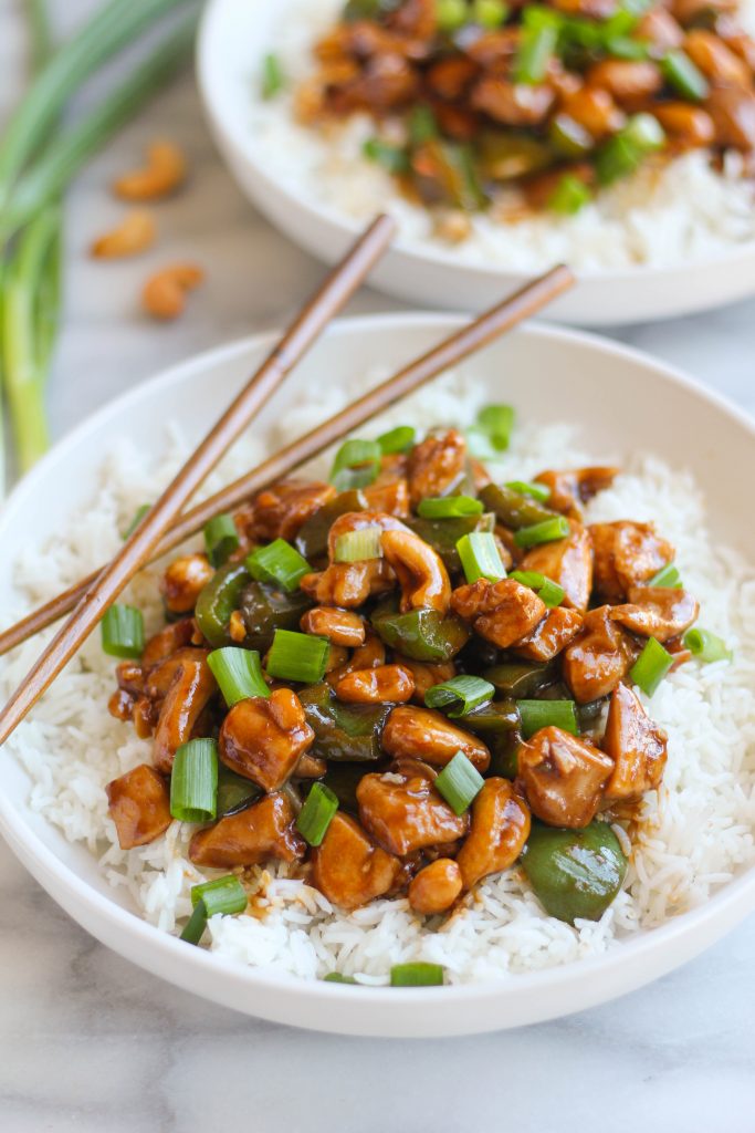 Savory and salty Cashew Chicken is very easy to throw together any night of the week! Chicken thigh bits combined with tender green bell peppers, crunchy cashews, and plenty of fresh green onions all served on a bed of white rice. 