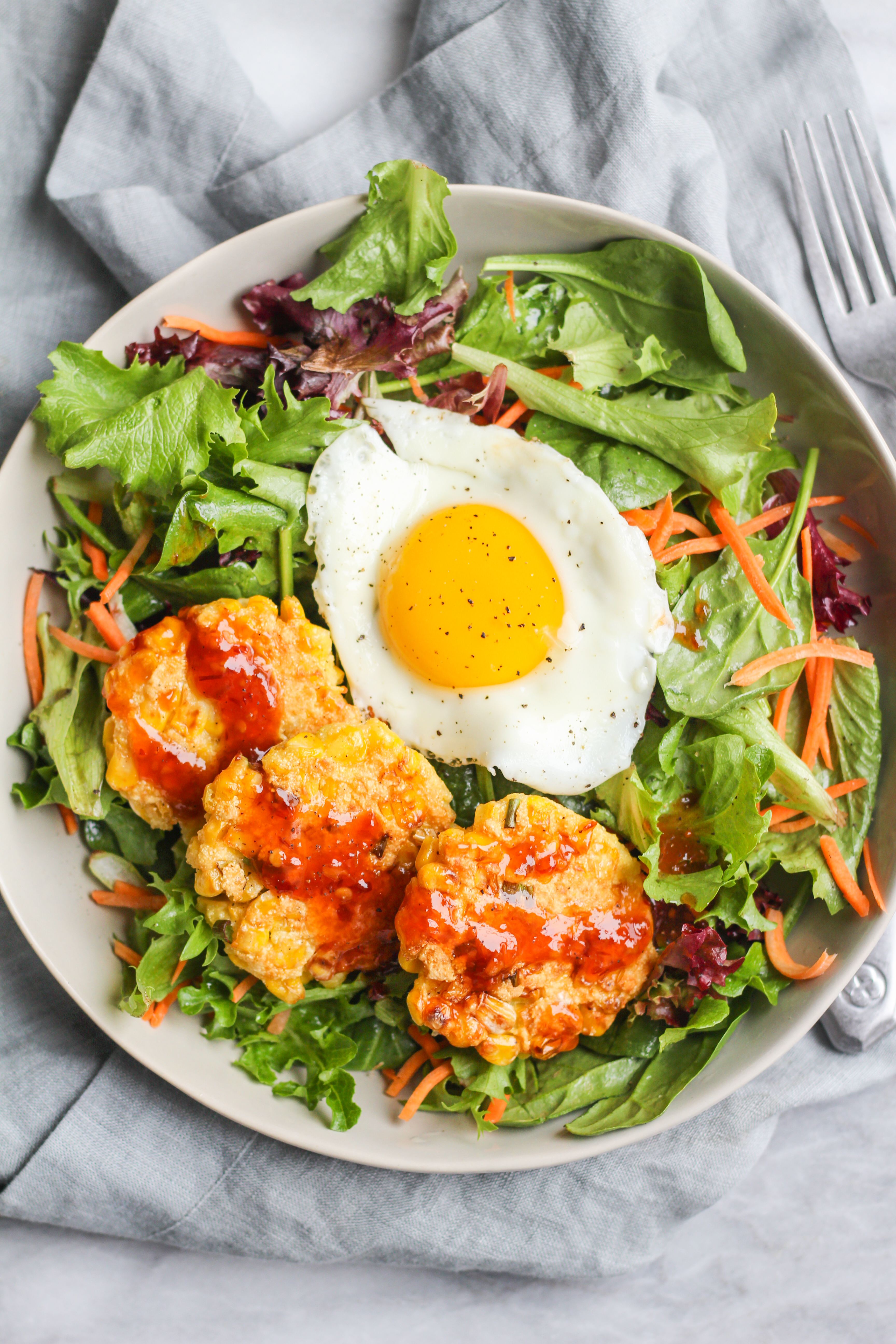 Corn Fritters with Spring Greens, Fried Egg & Sweet Chili Sauce