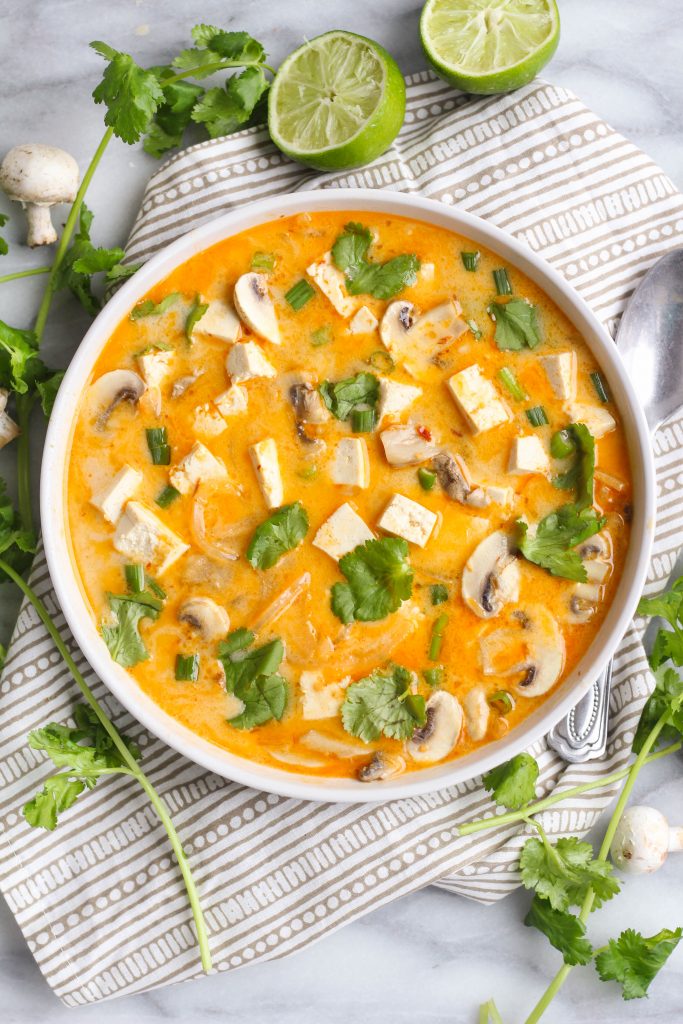 Tom kha gai, or Thai coconut chicken soup, is a spicy and sour hot soup made with coconut milk. The heat comes from chili-garlic sauce and the sour from the lime juice. You can use thinly sliced chicken or cubed tofu for a vegan version!
