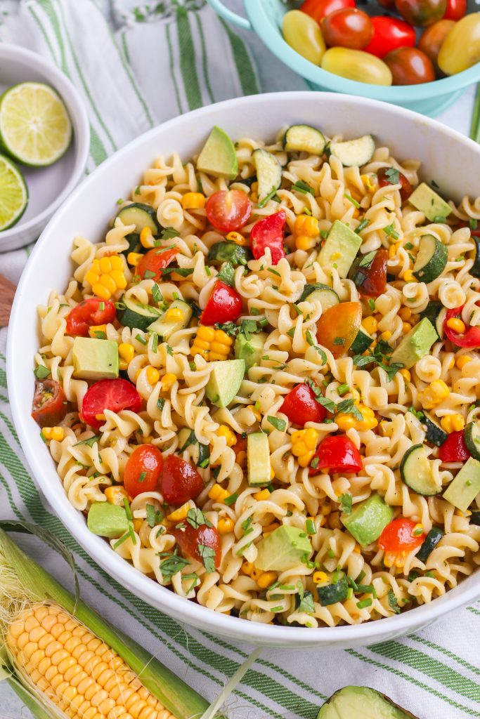 All of your favorite tastes of summer in one salad! Fresh corn, ripe avocado, sweet cherry tomatoes, and a spicy kick from jalapeno.  All tossed with al-dente fusilli pasta and hot lime dressing.