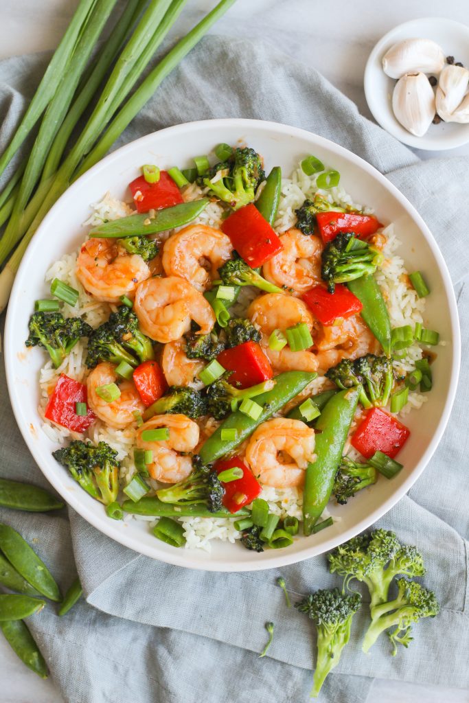 Spicy and tangy, this Szechuan shrimp comes together quickly. Tossed with broccoli, snap peas, and red bell pepper and served on a bed of basmati rice.