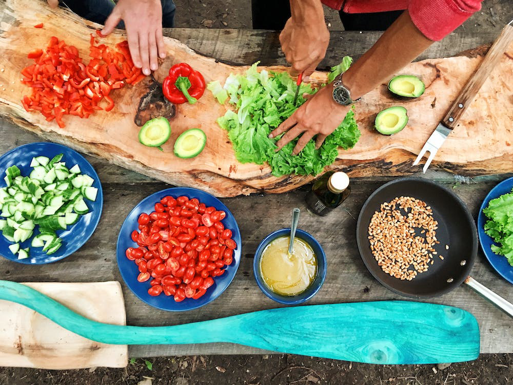 Person cutting vegetables on a wooden table